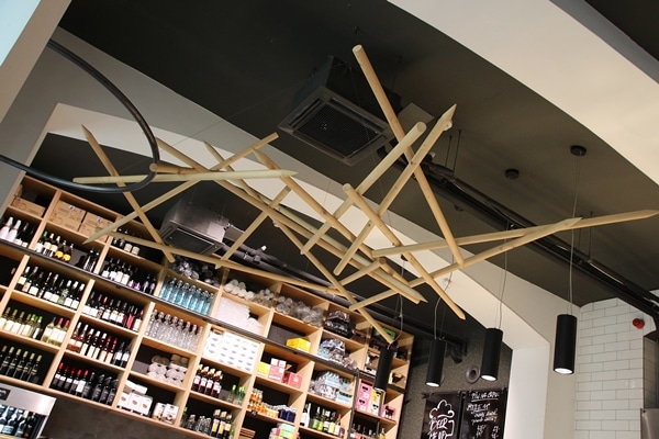 the interior of a restaurant with giant wooden skewers hanging from the ceiling