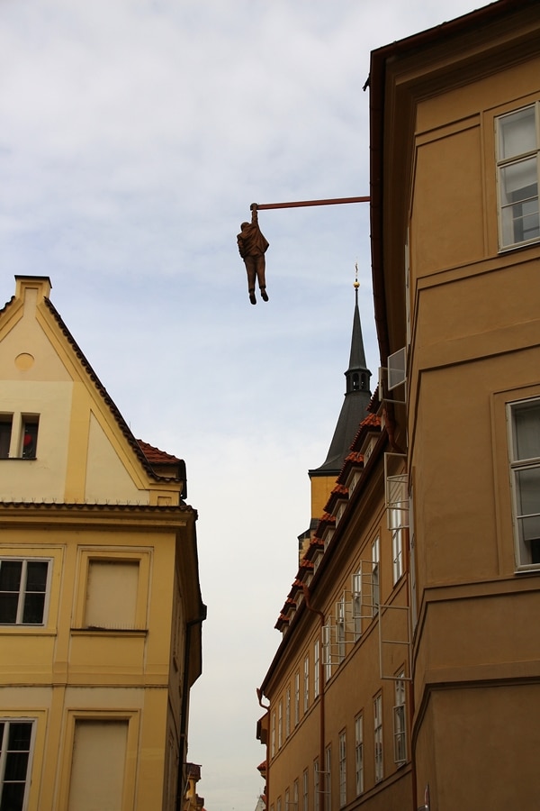 a statue of a man hanging from a building