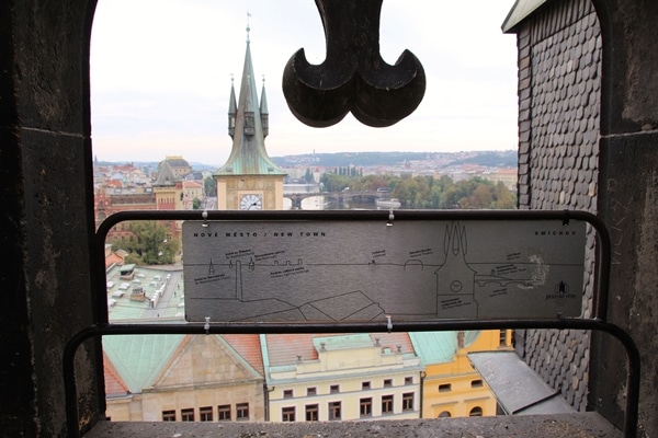 a rooftop view of Prague through a window opening