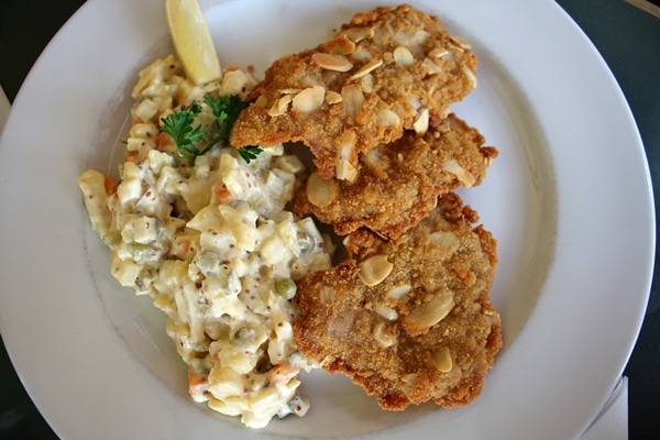 a plate of schnitzel and potato salad