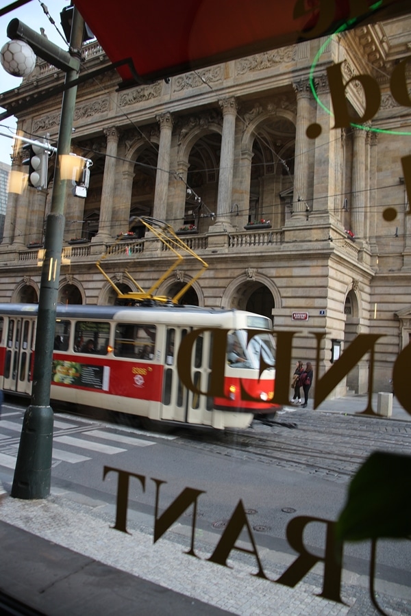 a red tram driving down the street