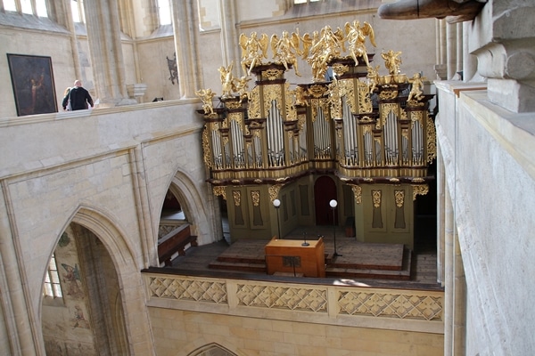 large church organ with gold figurines on top