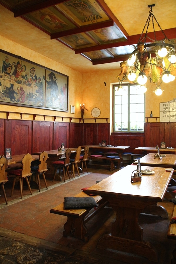 interior of a restaurant with long tables and colorful art