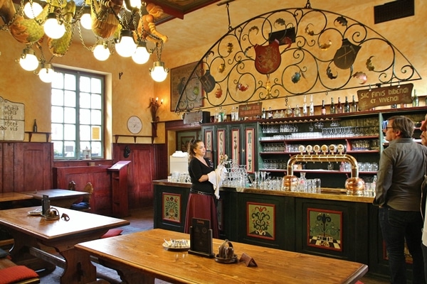the interior of a restaurant with a server standing at the bar