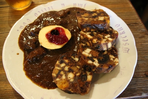 stewed meat with bread dumplings on the side