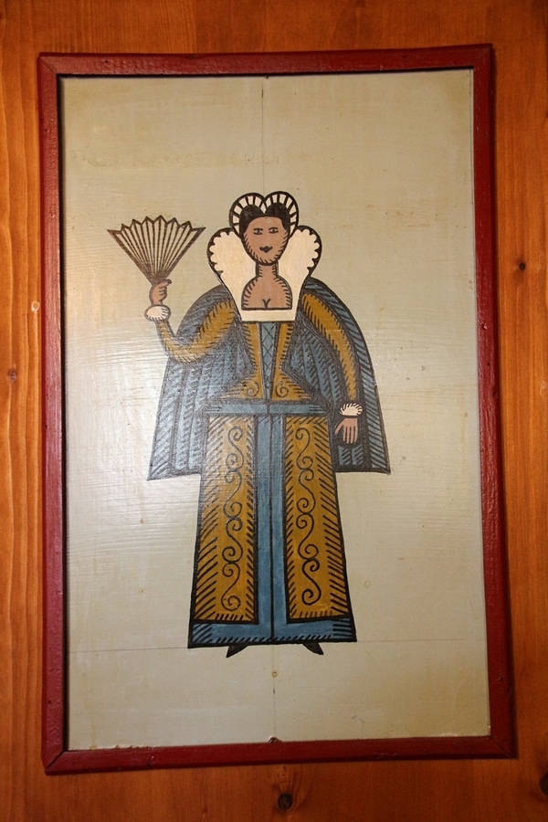 A painting of a woman hanging on a wall