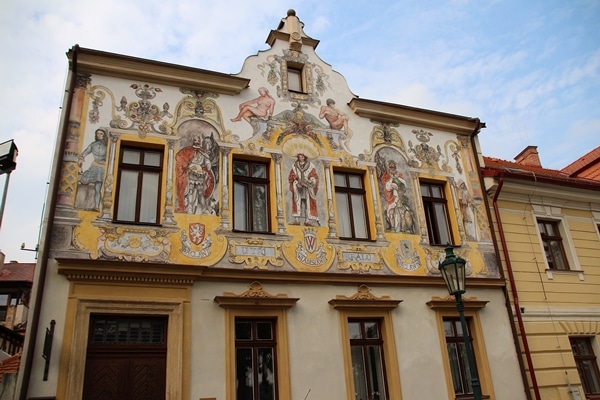 a building with colorful frescoes painted on it