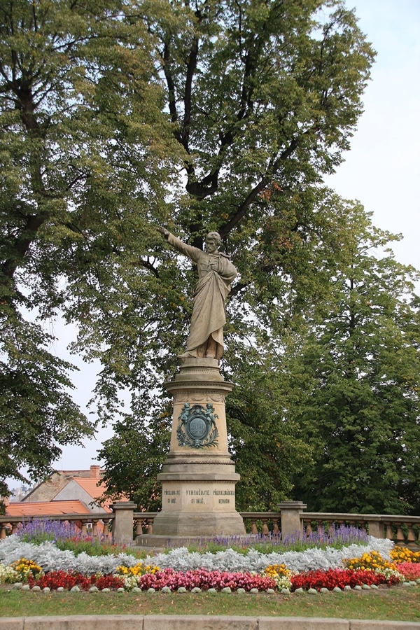 a statue under some trees