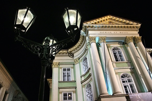 a streetlamp in front of a building at night