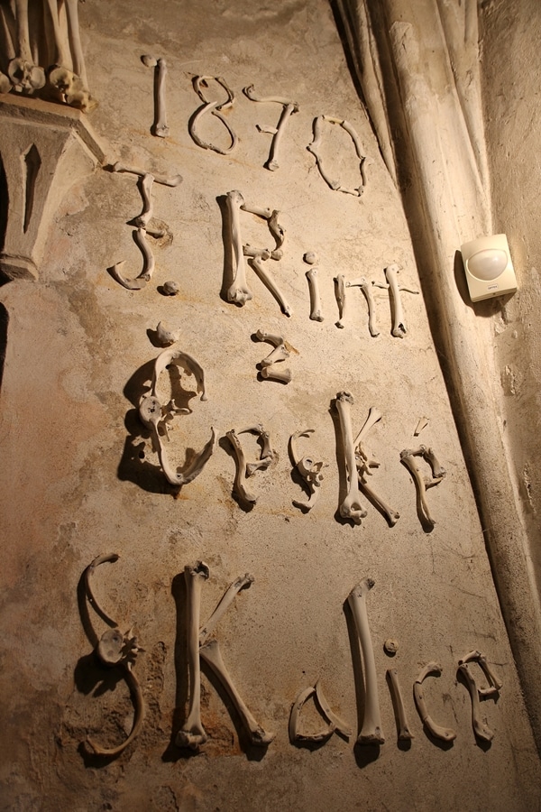 words written on a wall with human bones