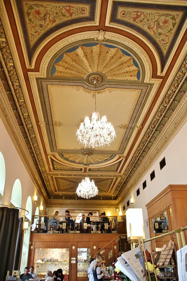 colorfully painted restaurant ceiling with glass chandeliers