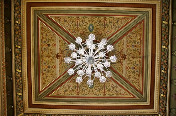 an elaborately decorated vaulted ceiling with a glass chandelier