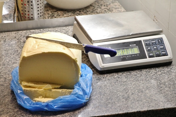 a large slab of butter next to a digital scale