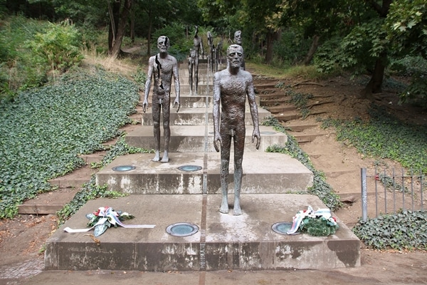 statues of men on stairs