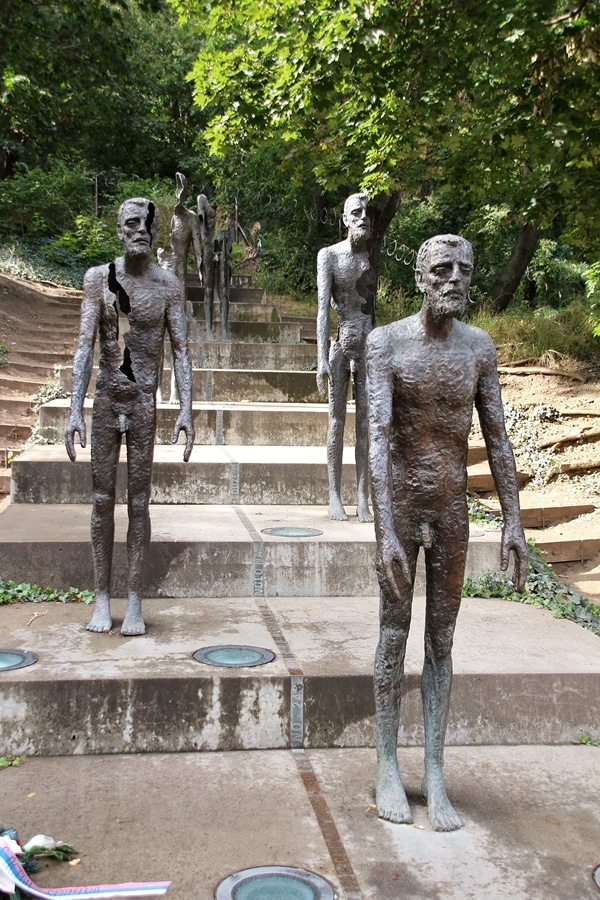 statues of men standing on steps