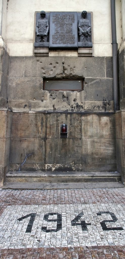 stone wall riddled with bullet holes