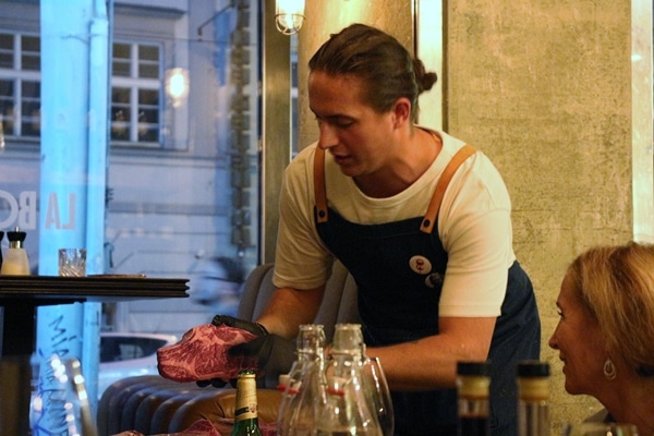 a man holding a large uncooked steak