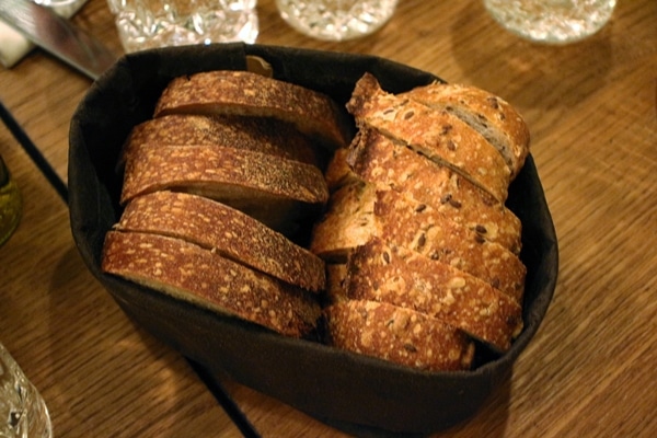 a bread basket with 2 varieties of bread