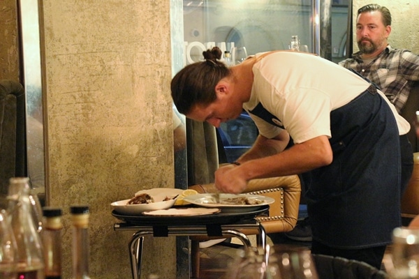 A man filleting a cooked fish