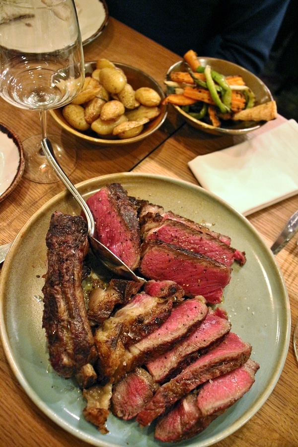 A large cooked steak sliced into pieces