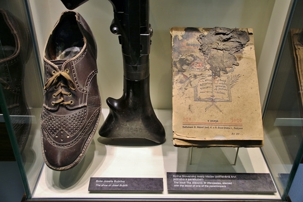 a shoe and book in a museum display