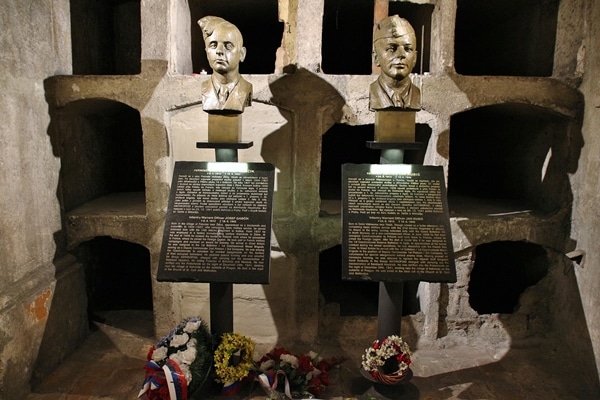 busts of people\'s heads in a crypt