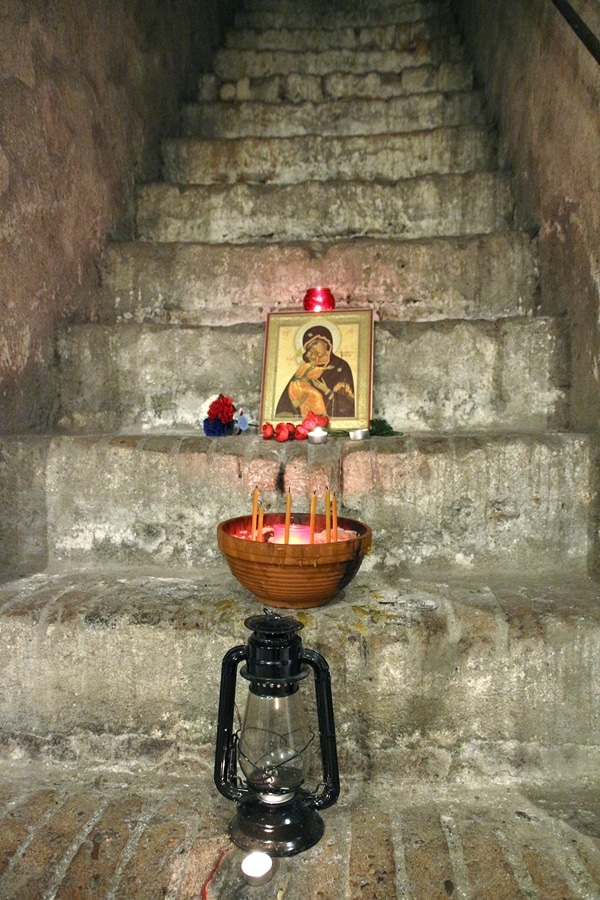 candles and a religious photo on stone steps