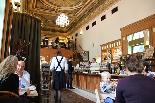 the interior of a restaurant with glass chandeliers