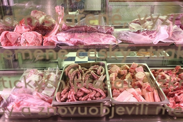 sausages and meats on display in a meat shop