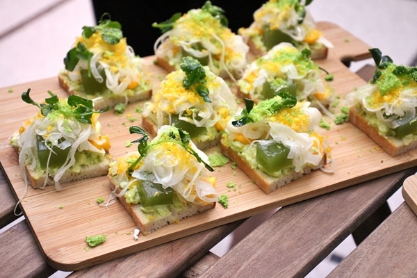 open-faced sandwiches on a wooden board