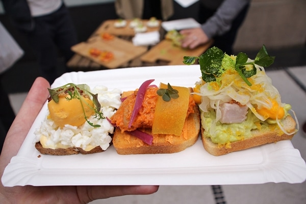 3 different varieties of open-faced sandwiches on a white plate