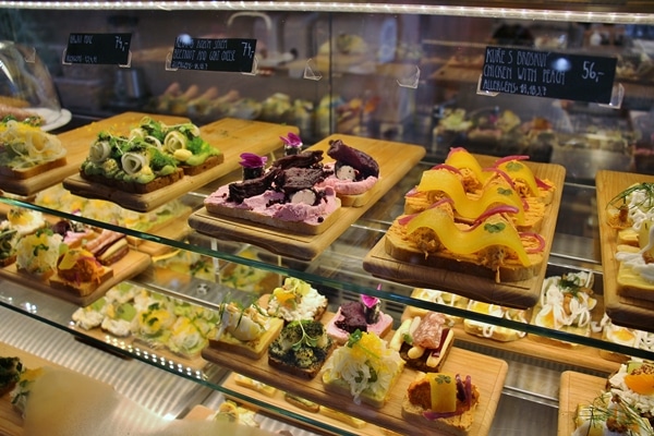 a variety of open-faced sandwiches in a display case