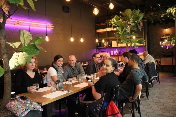 A group of people sitting at a table in a restaurant