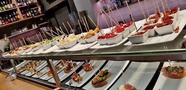 a buffet of food on skewers