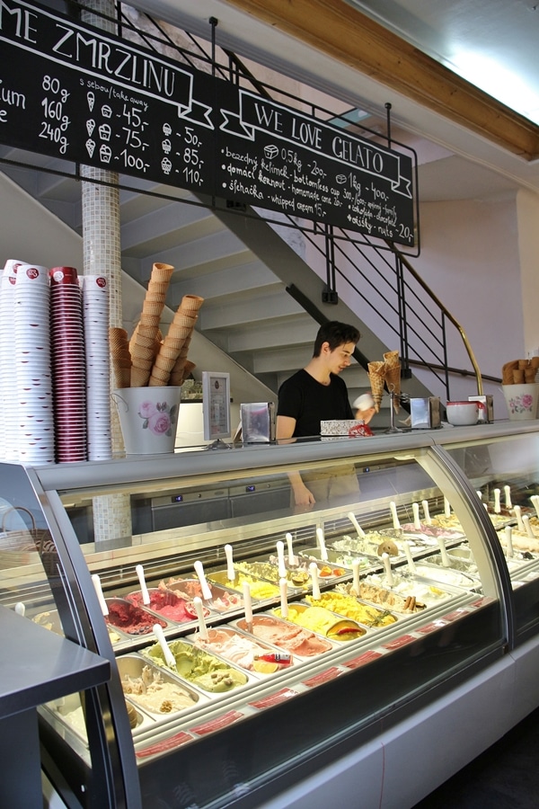 interior of an ice cream shop with a display case of gelatos and sorbets