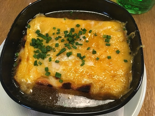 onion soup topped with melted yellow cheese and chopped chives