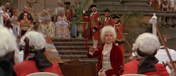 screenshot from the film Amadeus of Mozart conducting outdoors