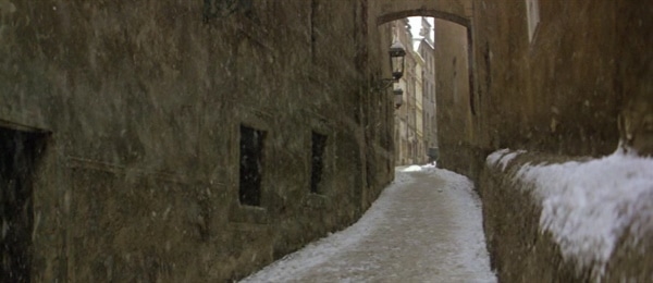 screenshot from the film Amadeus of a snow covered narrow street