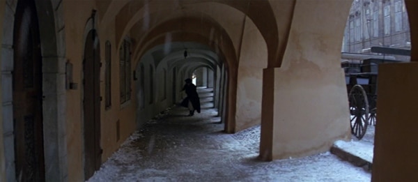 screenshot from the film Amadeus of a man walking in the snow