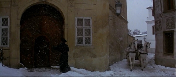 screenshot from the movie Amadeus of a house surrounded in snow