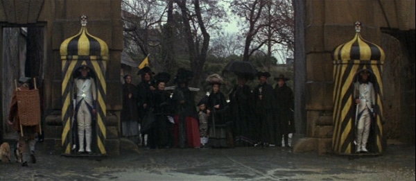 screenshot from the film Amadeus of a crowd standing in the rain