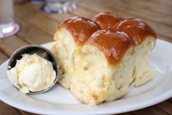 bread rolls with butter on a white plate