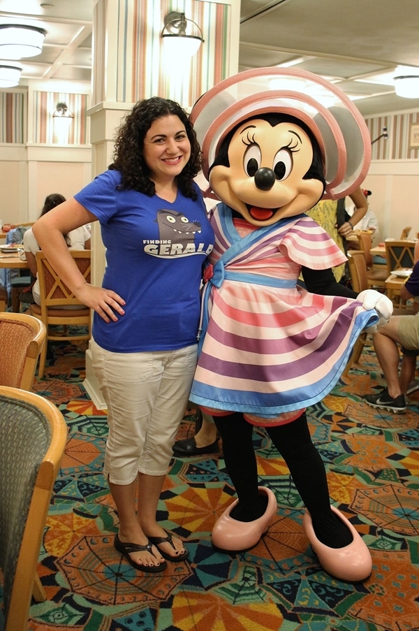 a woman posing with Minnie Mouse