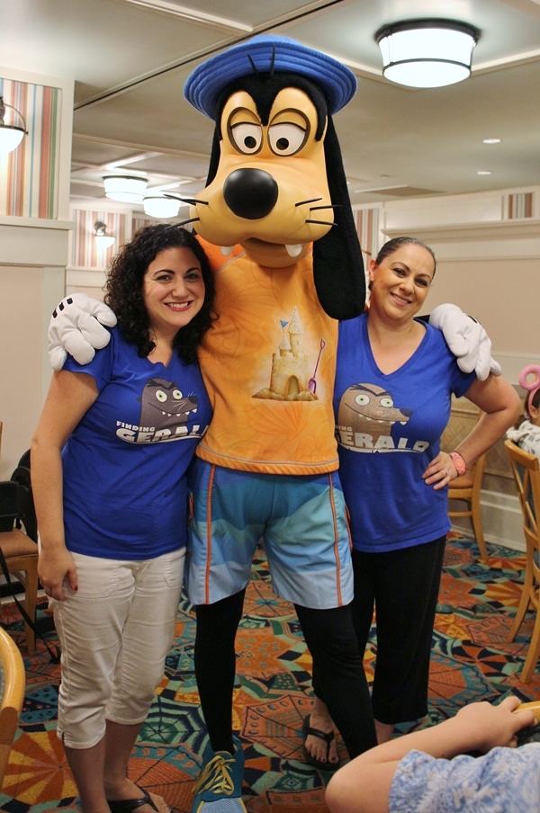 2 women posing with Goofy