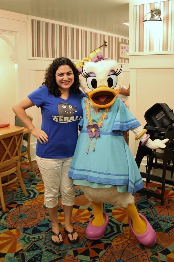 a woman posing with Daisy Duck