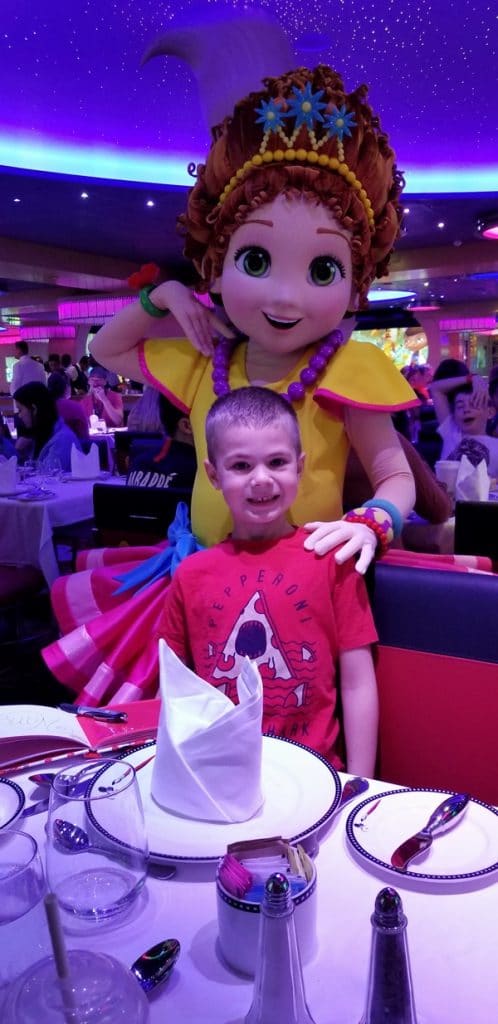 a boy posing with Princess Sophia from Disney Junior