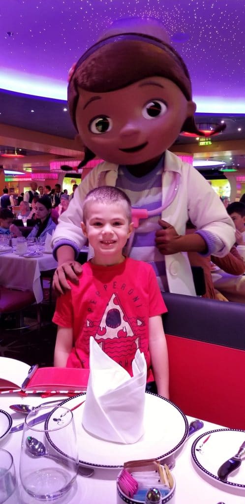 a boy posing with Doc McStuffins