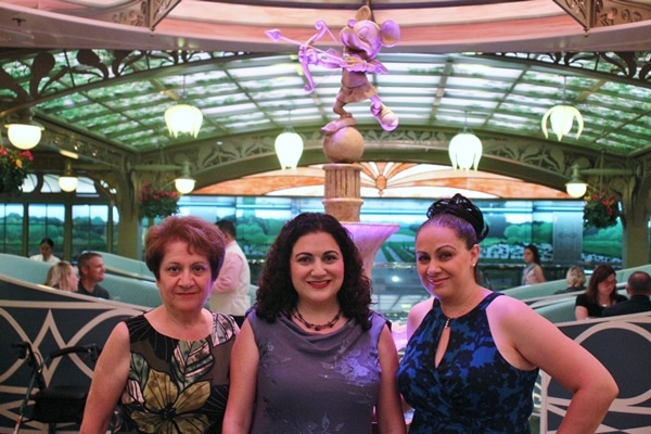 3 women posing in front of a fountain