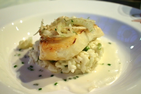 fish filet over risotto with peas