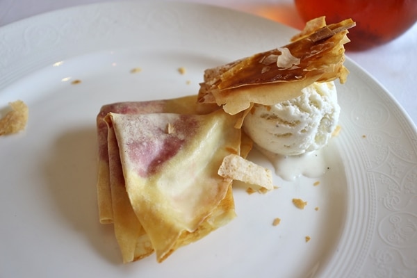 crepes with ice cream on a white plate